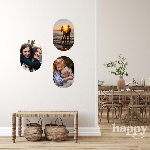 Personal photos printed as 30cm oval removable photo wall decals, arranged on a hallway wall